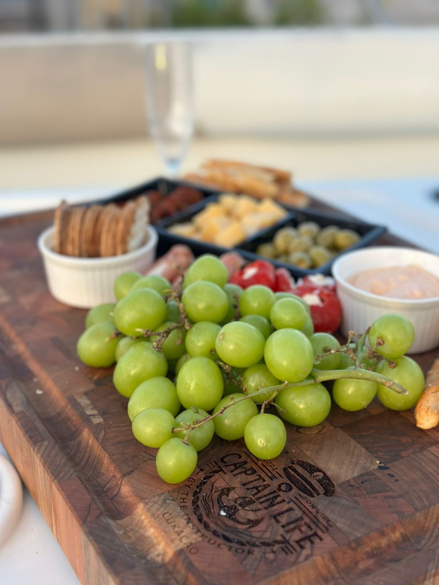 Captain Life Curaçao charcuterie board with grapes